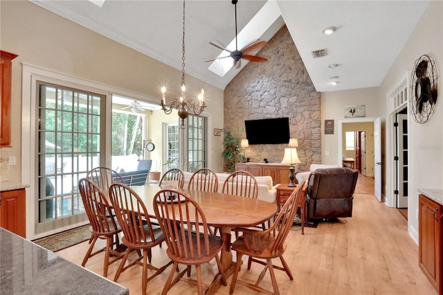 8608 Poinsettia Dr, Temple Terrace, FL 33637 - dining room featuring ceiling fan with notable chandelier, high vaulted ceiling, light hardwood / wood-style floors, and french doors