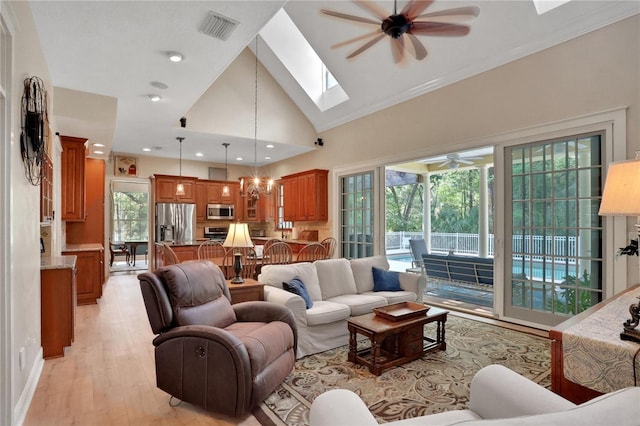 8608 Poinsettia Dr, Temple Terrace, FL 33637 - living room featuring a skylight, ceiling fan, high vaulted ceiling, light wood-type flooring, and ornamental molding