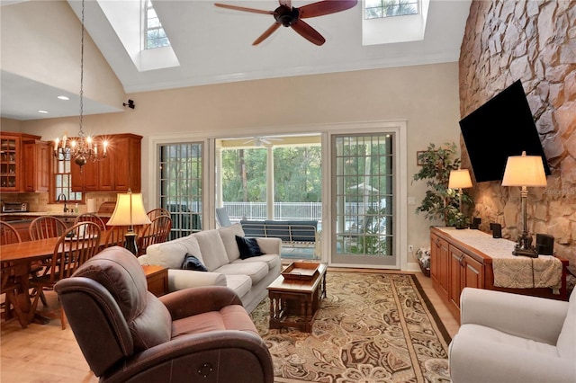 8608 Poinsettia Dr, Temple Terrace, FL 33637 - living room with a skylight, sink, ceiling fan with notable chandelier, and high vaulted ceiling