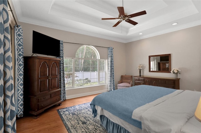 8608 Poinsettia Dr, Temple Terrace, FL 33637 - bedroom featuring wood-type flooring, ceiling fan, a tray ceiling, and crown molding