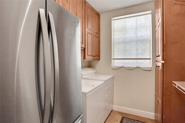 8608 Poinsettia Dr, Temple Terrace, FL 33637 - laundry room featuring washer and clothes dryer, cabinets, and light tile floors