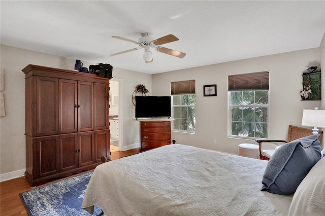 8608 Poinsettia Dr, Temple Terrace, FL 33637 - bedroom with wood-type flooring, ceiling fan, and ensuite bathroom