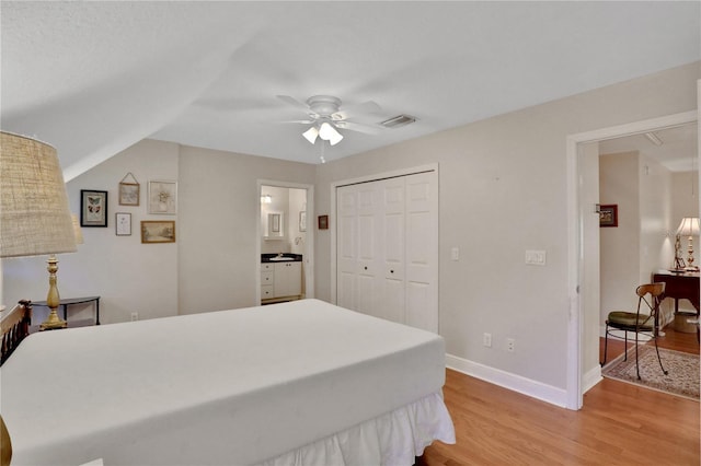 8608 Poinsettia Dr, Temple Terrace, FL 33637 - bedroom with a closet, light hardwood / wood-style floors, ceiling fan, and ensuite bathroom