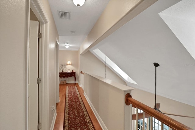 8608 Poinsettia Dr, Temple Terrace, FL 33637 - corridor featuring wood-type flooring and lofted ceiling with skylight