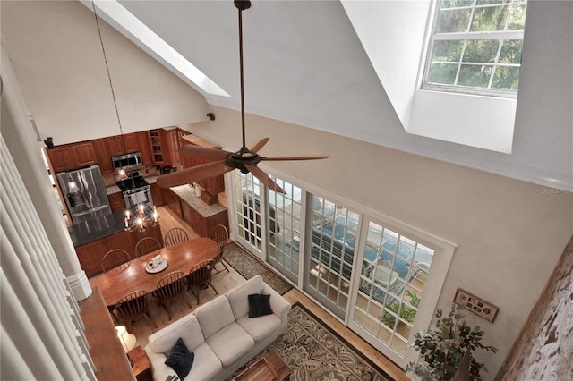 8608 Poinsettia Dr, Temple Terrace, FL 33637 - living room with a skylight, high vaulted ceiling, and ceiling fan