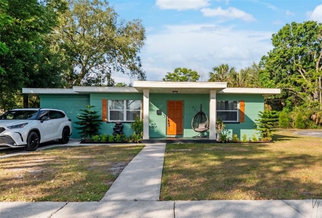 single story home featuring a front lawn