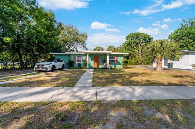 ranch-style home with a front yard