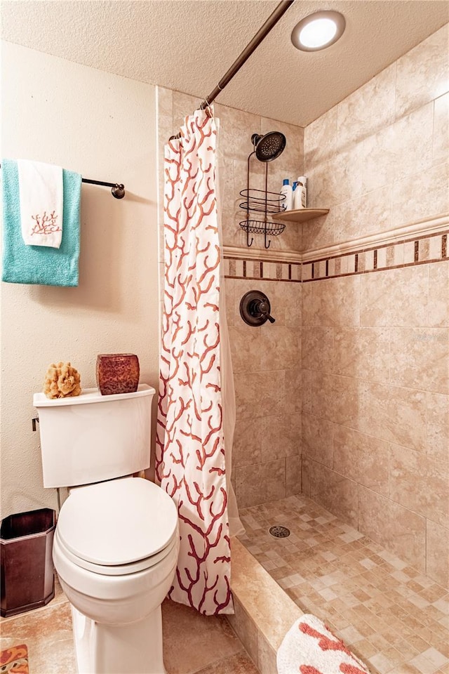 bathroom with a shower with shower curtain and toilet