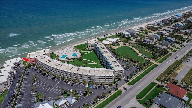 bird's eye view featuring a view of the beach and a water view