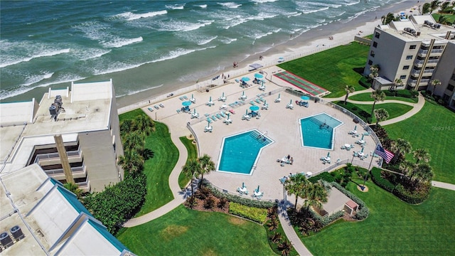 birds eye view of property with a water view and a view of the beach