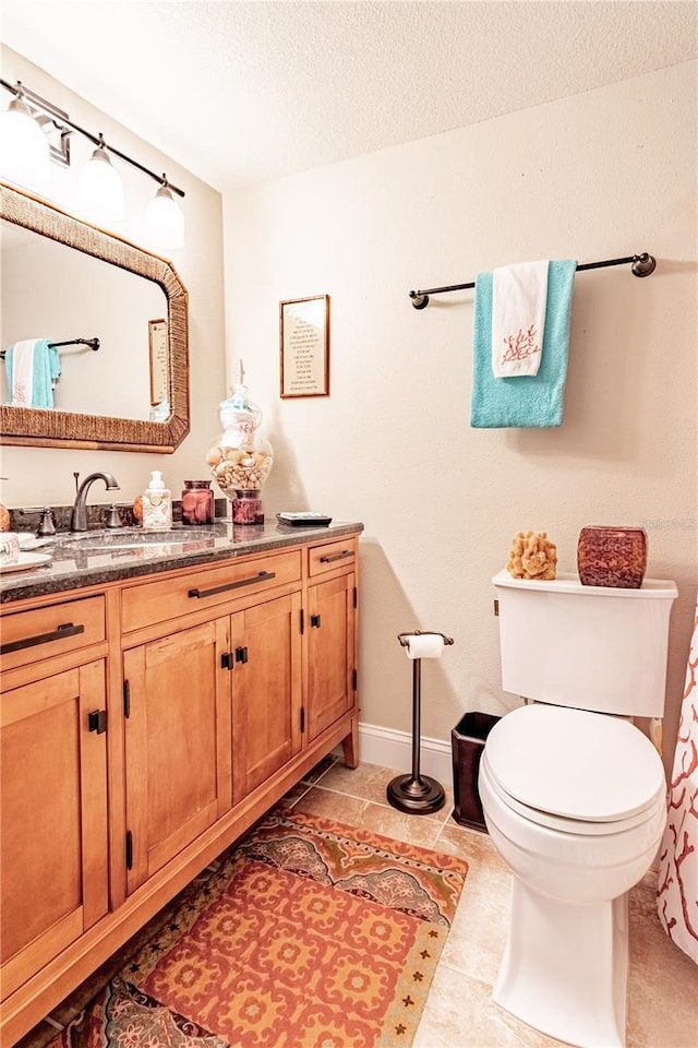 bathroom with vanity, a textured ceiling, and toilet