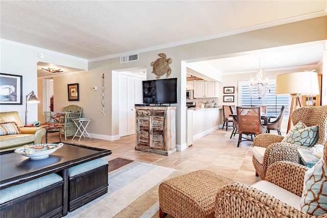 living room with a notable chandelier, ornamental molding, and a textured ceiling