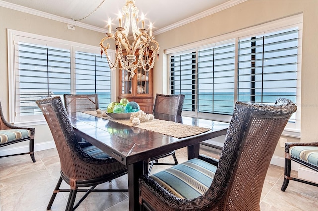 dining area featuring a chandelier and crown molding