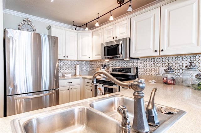 kitchen featuring white cabinets, appliances with stainless steel finishes, and tasteful backsplash