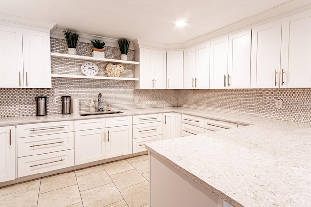 kitchen featuring white cabinets, sink, decorative backsplash, light stone countertops, and light tile patterned flooring