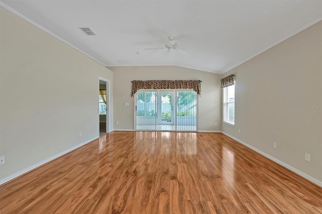 unfurnished room featuring ornamental molding, light wood-type flooring, vaulted ceiling, and ceiling fan