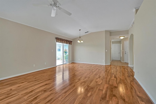 spare room with ornamental molding, lofted ceiling, ceiling fan with notable chandelier, and light hardwood / wood-style flooring