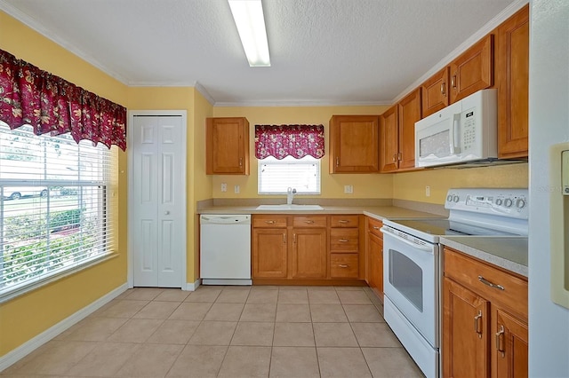 kitchen with white appliances, light tile flooring, a textured ceiling, sink, and ornamental molding