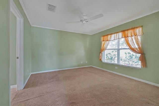 unfurnished room featuring crown molding, carpet, and ceiling fan