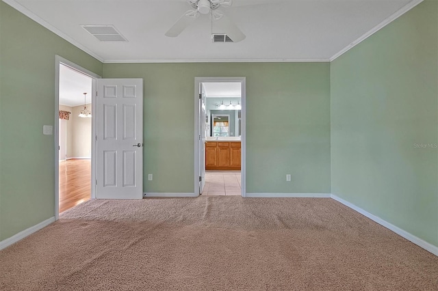 empty room with ornamental molding, ceiling fan, and light tile floors