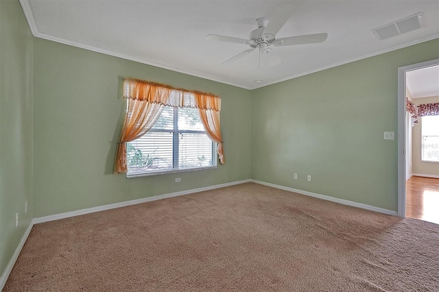 carpeted empty room featuring ornamental molding and ceiling fan