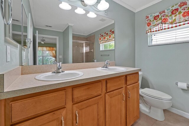 bathroom featuring ceiling fan, crown molding, double sink vanity, tile floors, and toilet