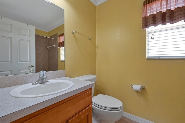 bathroom with crown molding, a wealth of natural light, vanity, and toilet