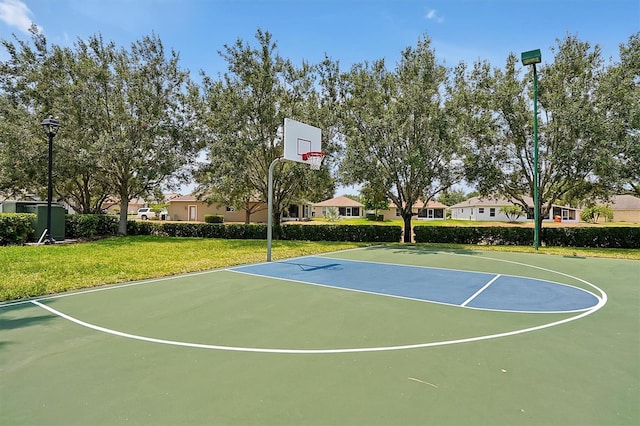 view of basketball court featuring a yard