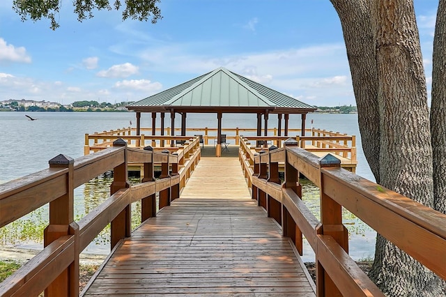 view of dock with a water view and a gazebo