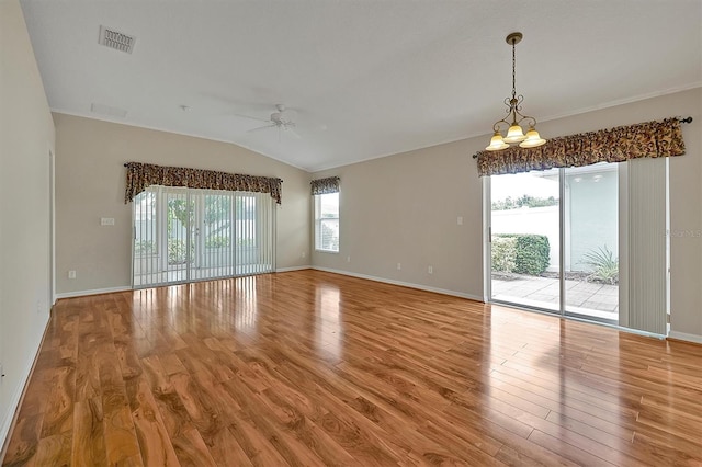 unfurnished room featuring ceiling fan with notable chandelier, vaulted ceiling, and light wood-type flooring