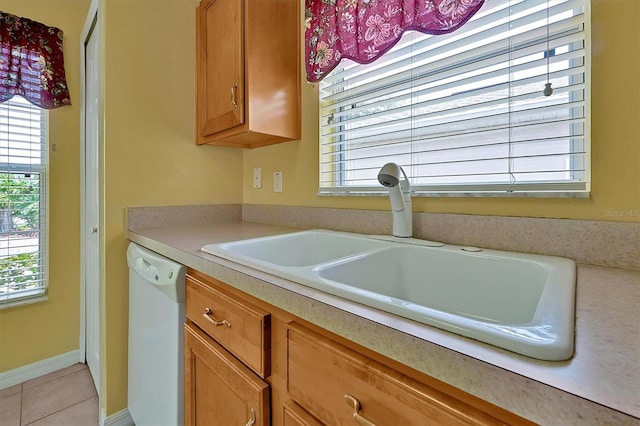 kitchen with sink, tile floors, and white dishwasher