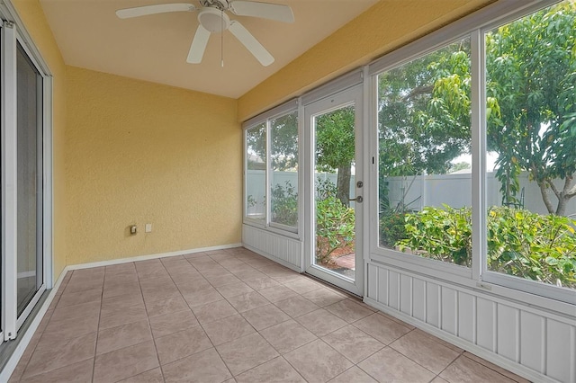 unfurnished sunroom with a wealth of natural light and ceiling fan