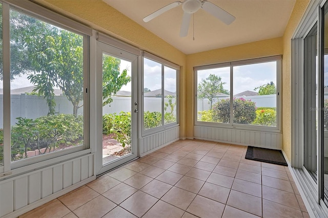 unfurnished sunroom with a wealth of natural light and ceiling fan