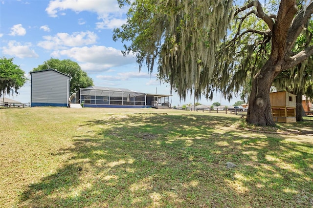 view of yard featuring a lanai and fence