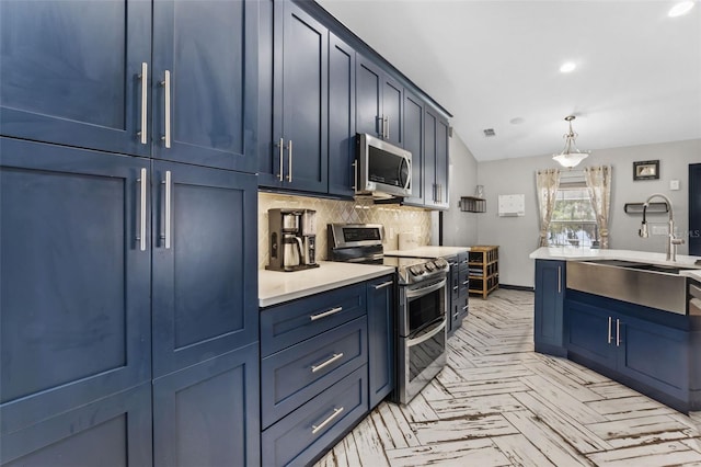 kitchen featuring blue cabinets, stainless steel appliances, backsplash, and light countertops