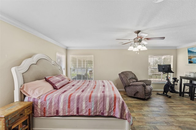 bedroom featuring a textured ceiling, wood finished floors, a ceiling fan, baseboards, and ornamental molding