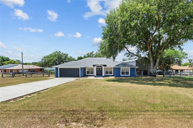 single story home with a garage and a front lawn