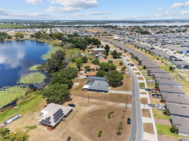 drone / aerial view with a water view and a residential view