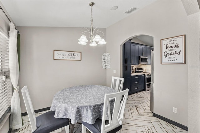 dining space with arched walkways, baseboards, visible vents, and a notable chandelier