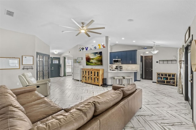 living room with high vaulted ceiling, arched walkways, visible vents, and recessed lighting