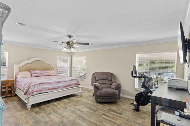 bedroom featuring ornamental molding, multiple windows, and wood finished floors