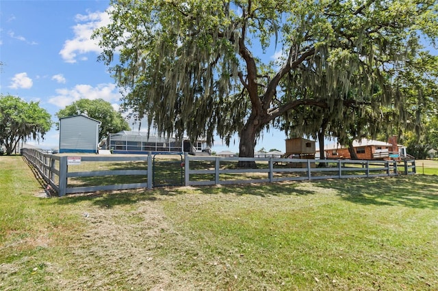 view of yard with fence and an outdoor structure