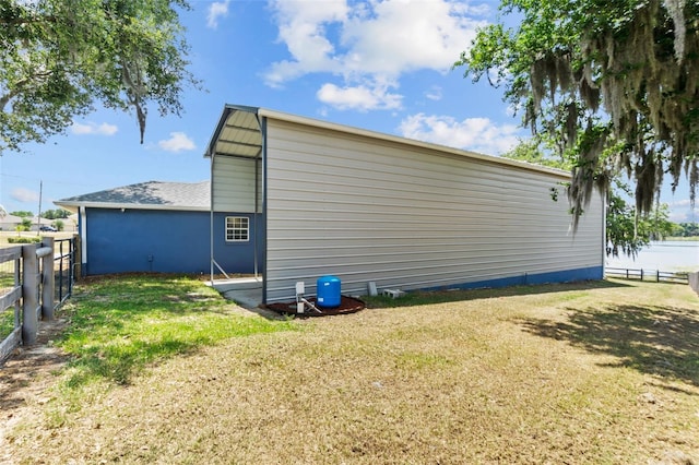 view of side of property featuring a yard and fence