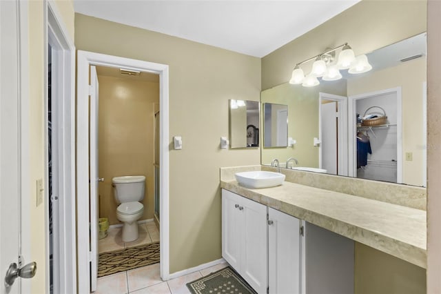 bathroom featuring toilet, tile flooring, and large vanity