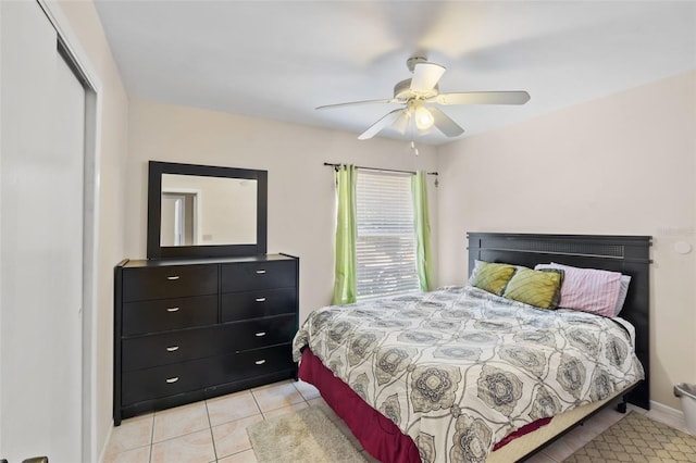 tiled bedroom with a closet and ceiling fan