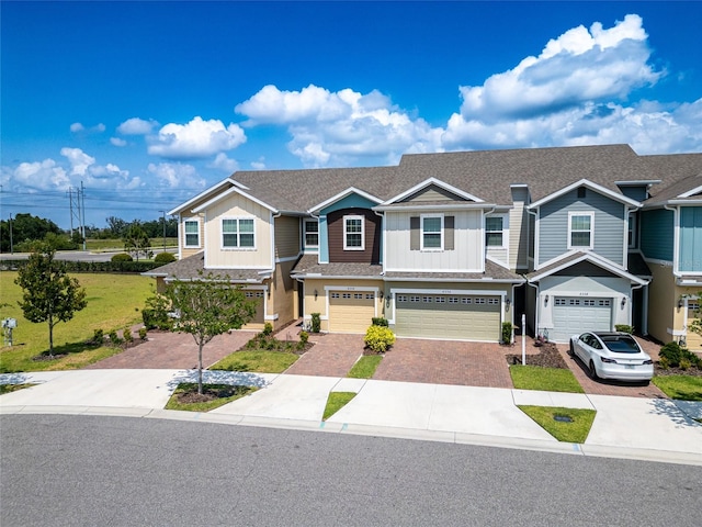 view of front of property with a front yard and a garage