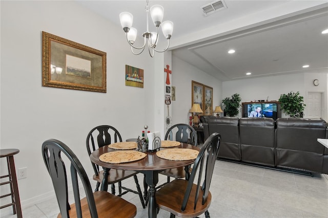 dining room featuring a chandelier and light tile flooring