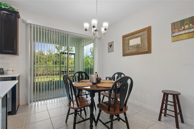 tiled dining space with a chandelier