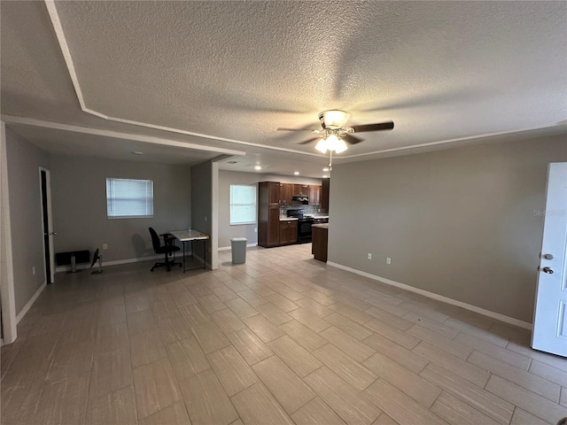 interior space with light hardwood / wood-style floors, a textured ceiling, and ceiling fan