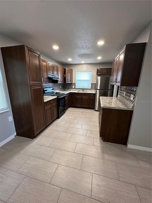 kitchen with black electric range oven, sink, light tile flooring, and tasteful backsplash